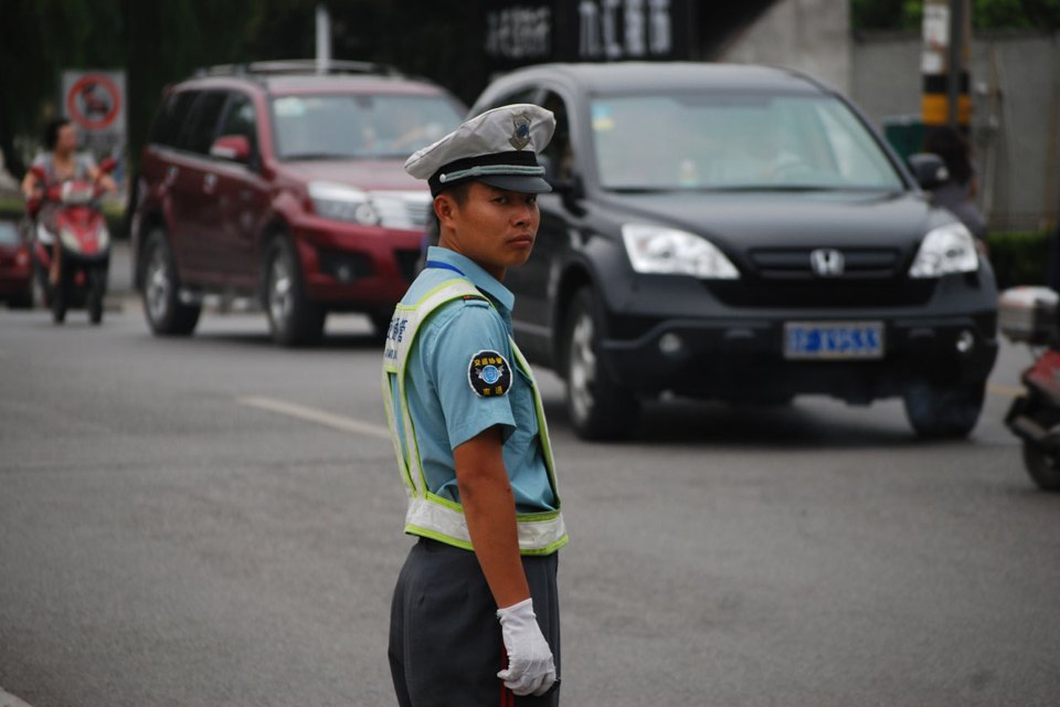 A traffic officer directing vehicles, illustrating controlled routing.