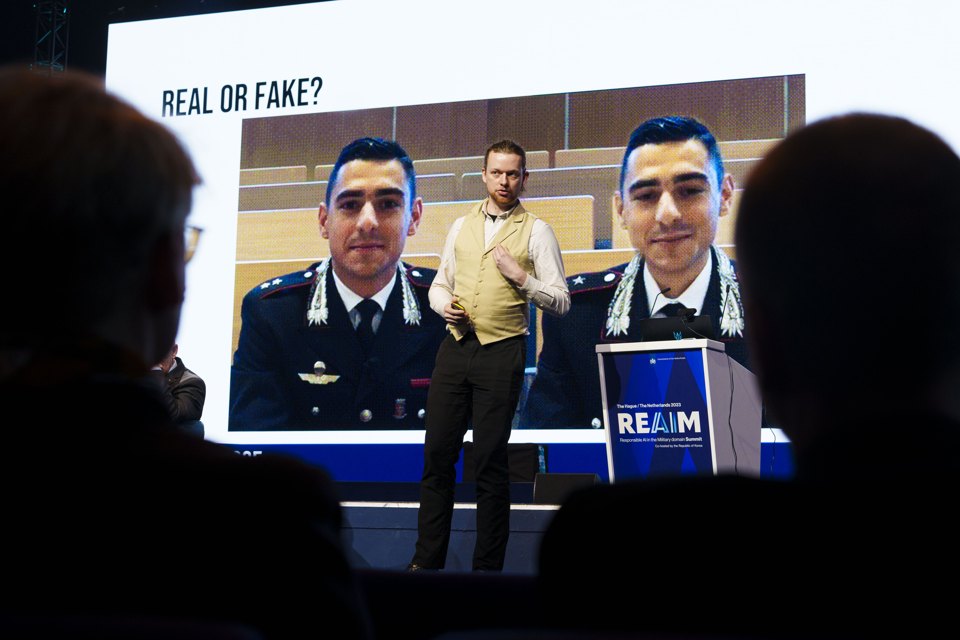 Conference screen asking whether manipulated digital content is real or fake